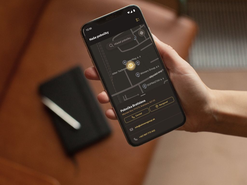 Person holding a phone showing iWinners branch locator with map