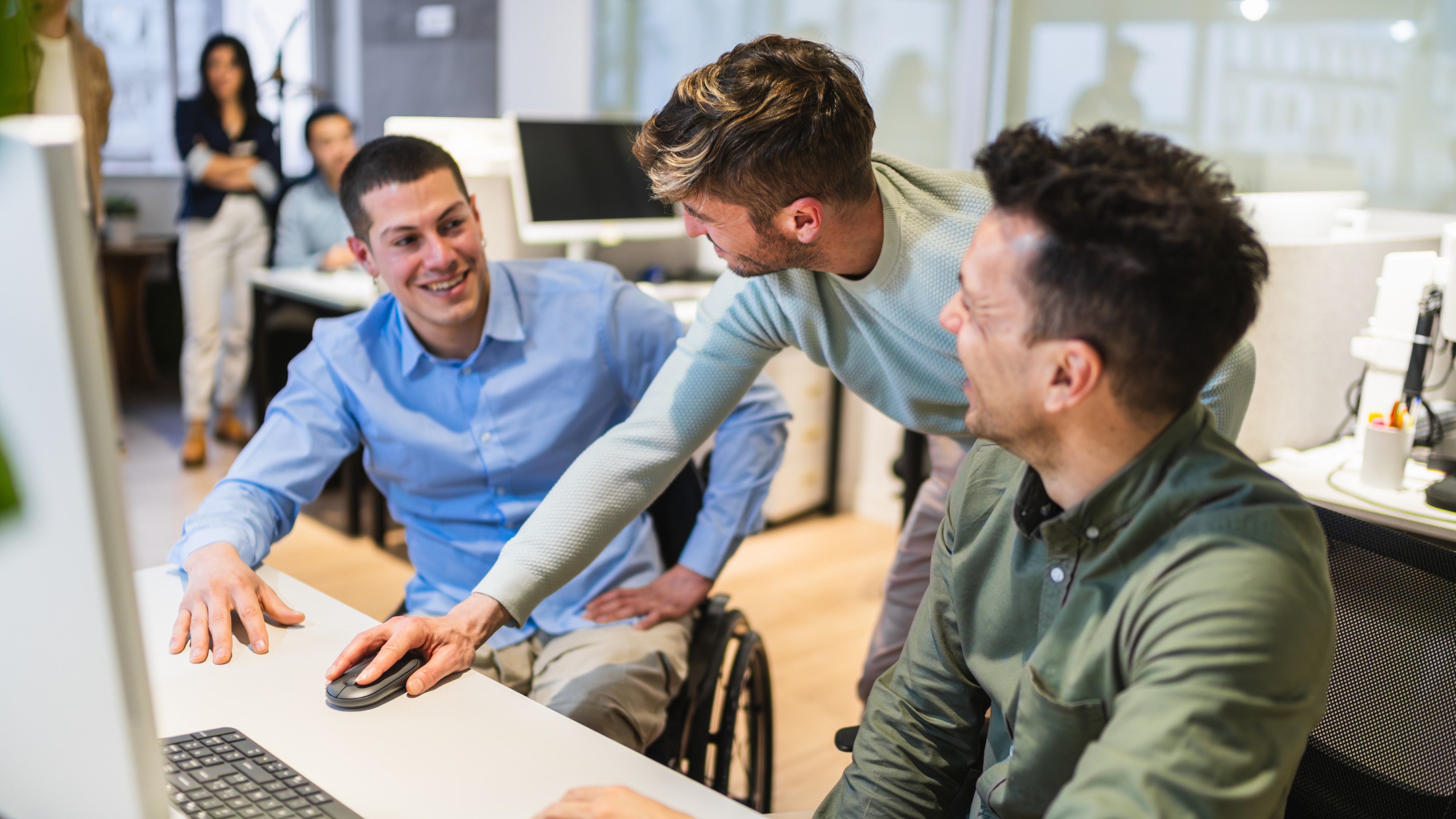 Team collaborating at a desk in a modern office